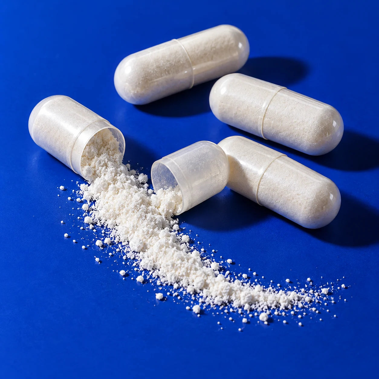 Open and closed capsules on a cobalt blue surface