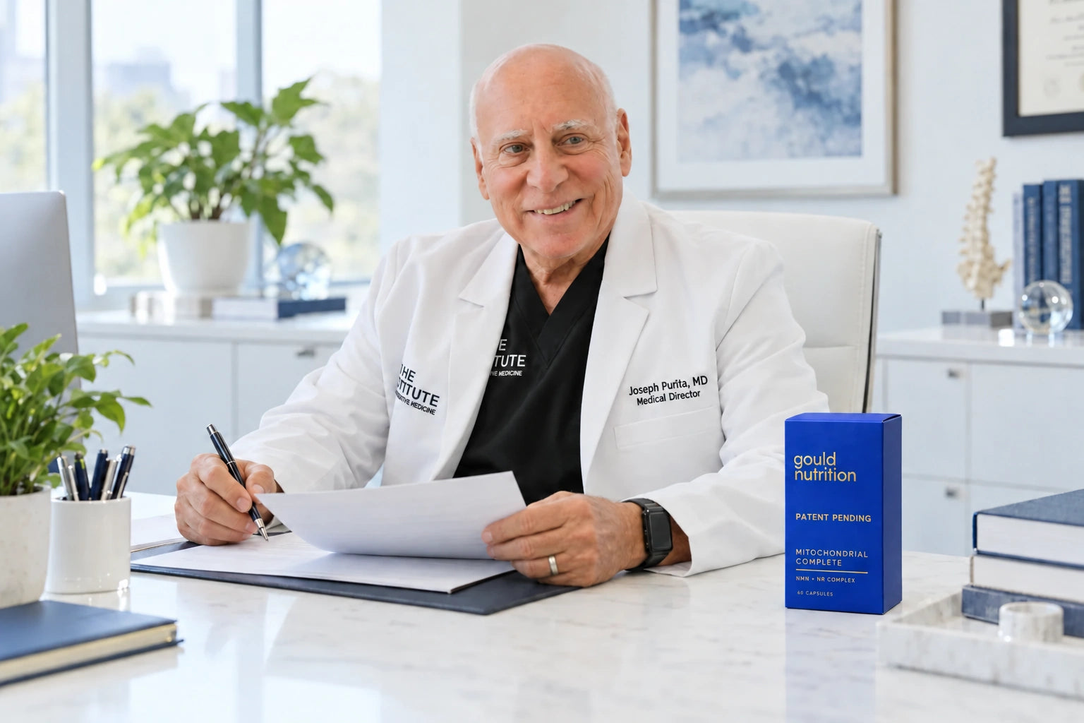 Dr. Joseph Purita seated with Gould Nutrition products