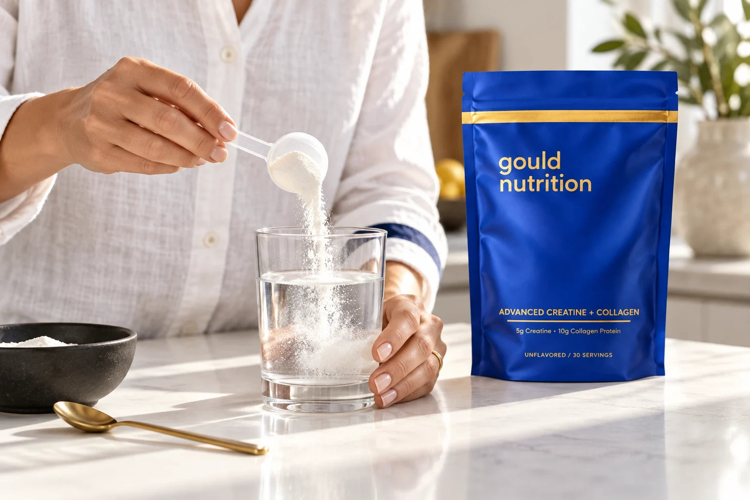 A scoop of Gould Nutrition powder being mixed into a glass